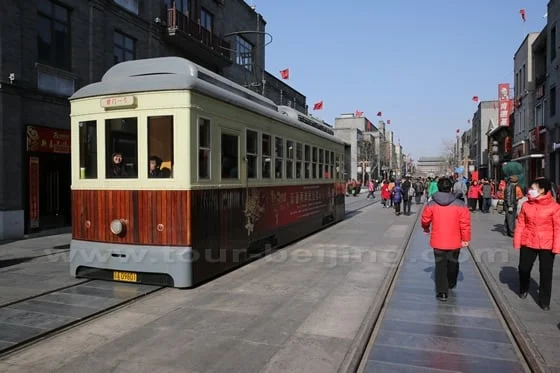 Traditional-style tram and pedestrians on Qianmen shopping street