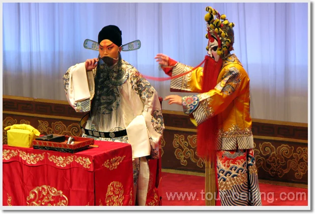 Two Peking opera performers in embroidered costumes and painted stage makeup
