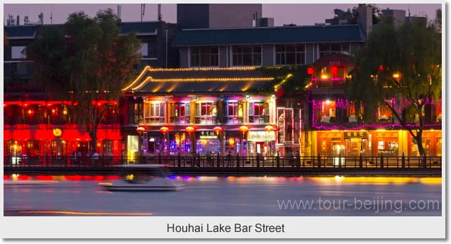 Colourful lakeside lights reflected on the water at Houhai after dusk