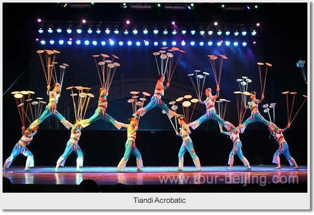 A troupe of acrobats balancing and spinning plates under stage lights